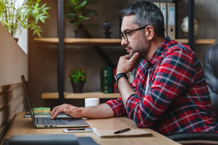 man checking email at desk